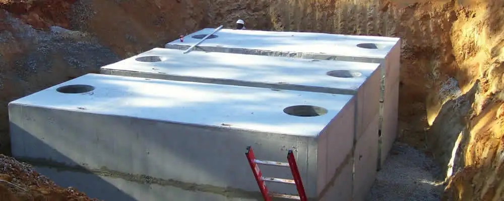 Septic tank installation site with a newly placed concrete tank in Spokane, WA